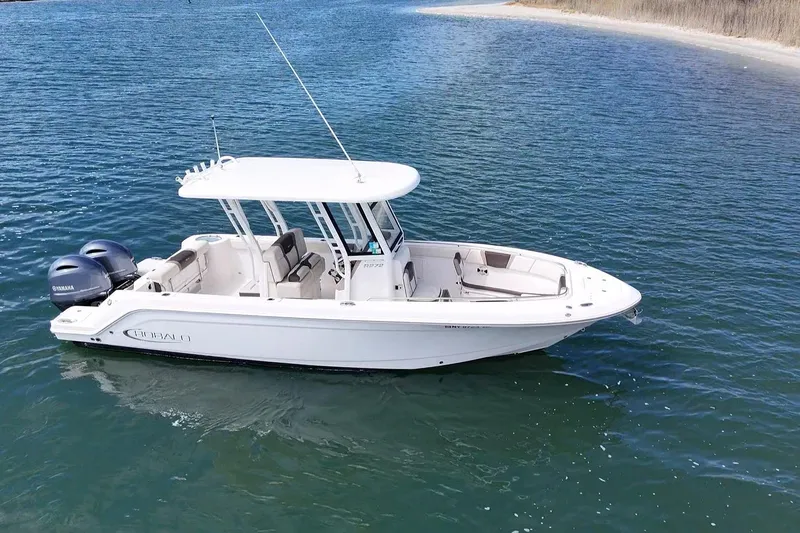 Slide: The Image of 2020 Robalo R272 Center Console boat on calm blue water. - 13