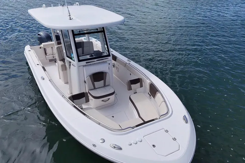 Slide: The Image of 2020 Robalo R272 Center Console boat on water, showcasing sleek design and spacious deck. - 15