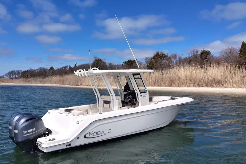 Slide: The Image of 2020 Robalo R272 Center Console boat on water, clear sky background. - 16