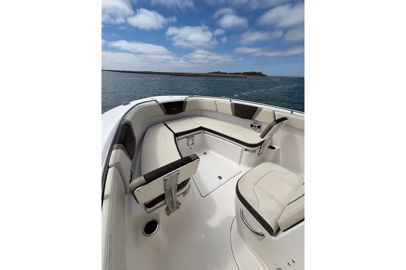 Slide: The Image of 2020 Robalo R272 Center Console boat interior with seating, on calm water. - 21