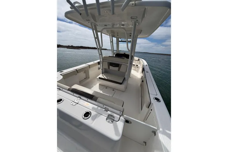 Slide: The Image of 2020 Robalo R272 Center Console boat on water, showcasing spacious deck and seating. - 25