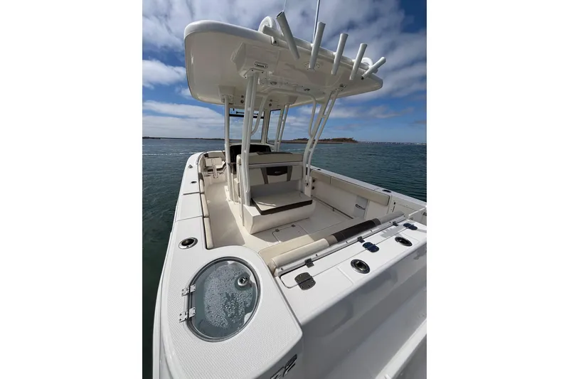 Slide: The Image of 2020 Robalo R272 Center Console boat on water, showcasing spacious deck and seating. - 26