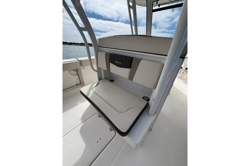 Slide: The Image of 2020 Robalo R272 Center Console boat seating with cushioned backrest and storage. - 27
