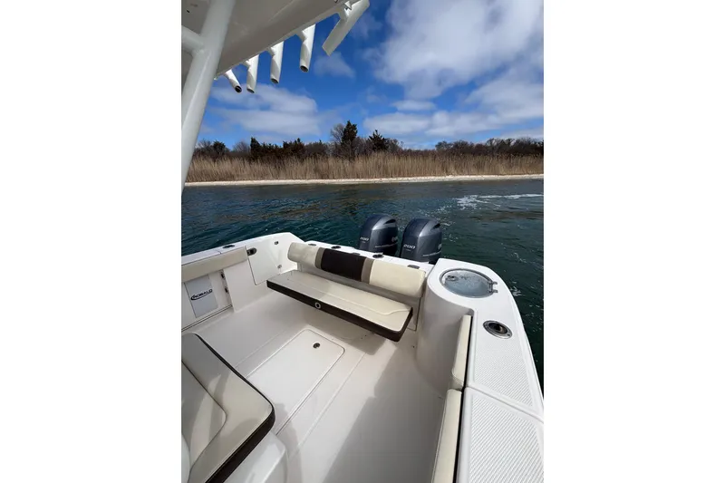 Slide: The Image of 2020 Robalo R272 Center Console boat on water near shoreline. - 28