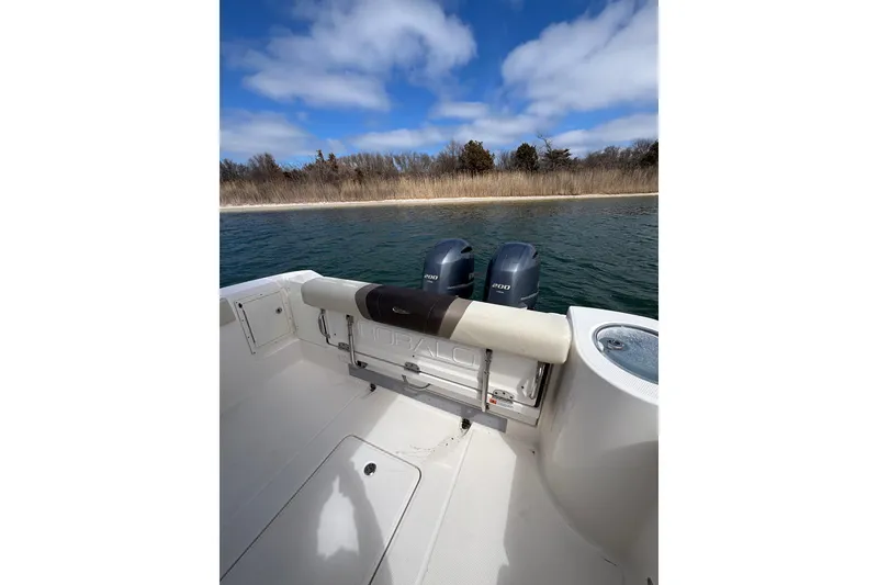 Slide: The Image of 2020 Robalo R272 Center Console boat with twin engines on a calm lake. - 30