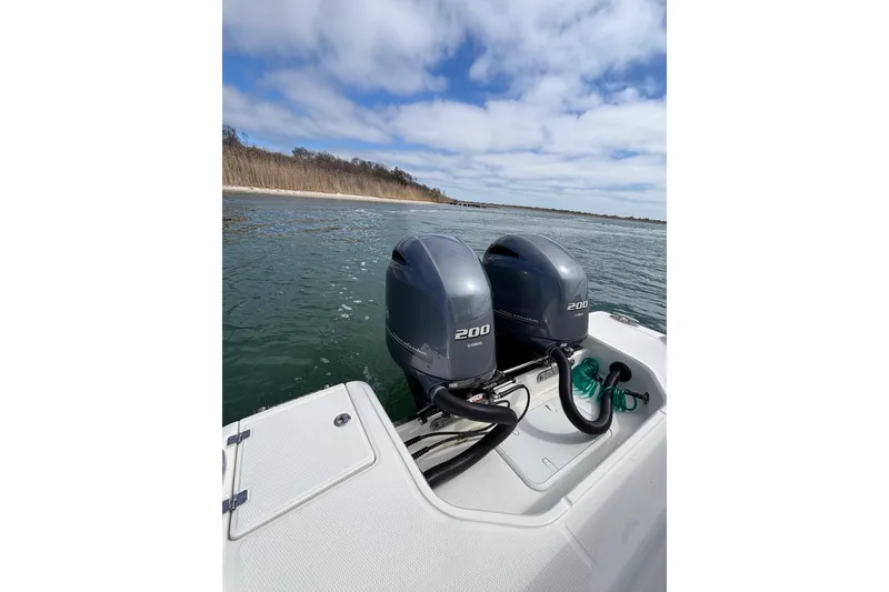 Slide: The Image of 2020 Robalo R272 Center Console with twin 200 horsepower engines on open water. - 32