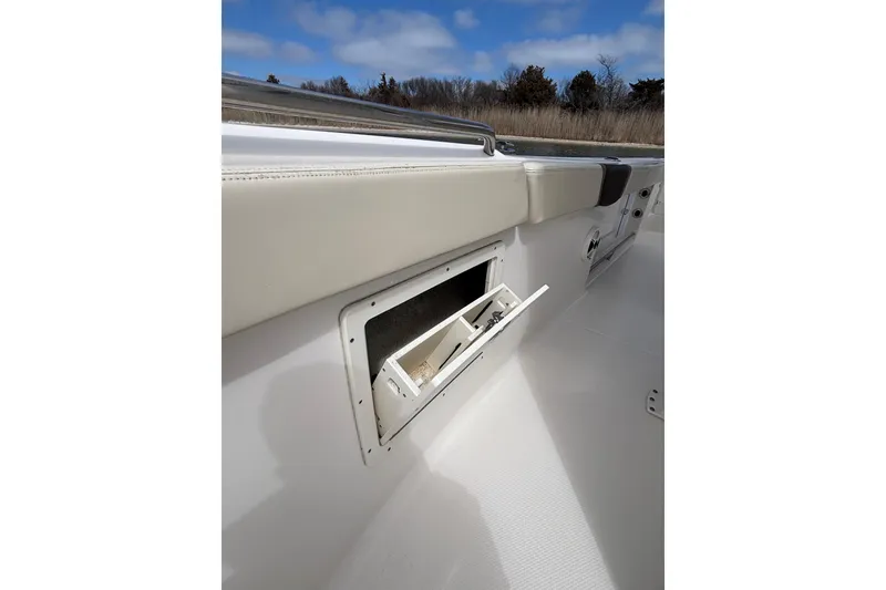 Slide: The Image of 2020 Robalo R272 Center Console boat with open storage compartment. - 37