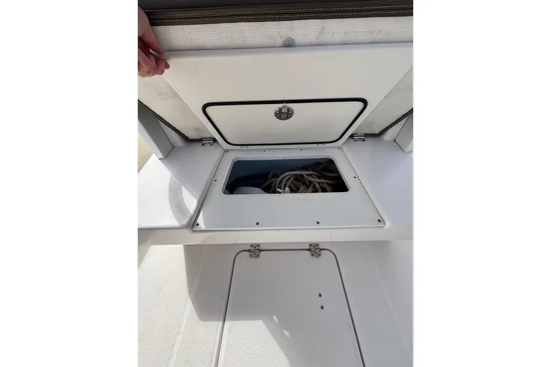 Slide: The Image of 2020 Robalo R272 Center Console boat storage compartment with ropes inside. - 39
