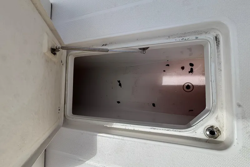 Slide: The Image of Open storage compartment on 2020 Robalo R272 Center Console boat. - 41