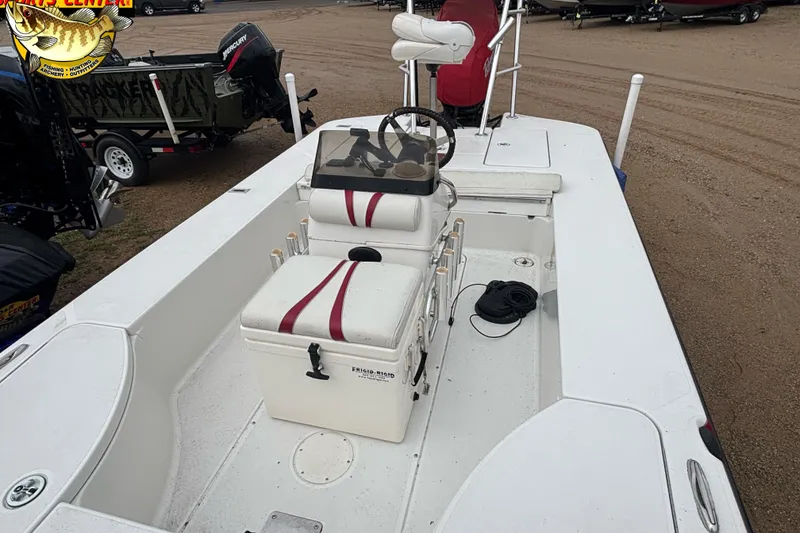 Slide: The Image of 2005 Ranger 223 Cayman boat interior with seating and steering console. - 6