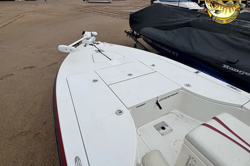 Slide: The Image of 2005 Ranger 223 Cayman boat on sandy shore, featuring a clean white deck. - 9