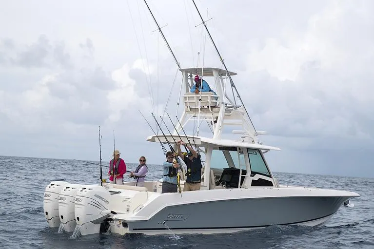 Slide: The Image of Manufacturer Provided Image: 2025 Boston Whaler 380 Outrage fishing boat on open sea with passengers. - 5