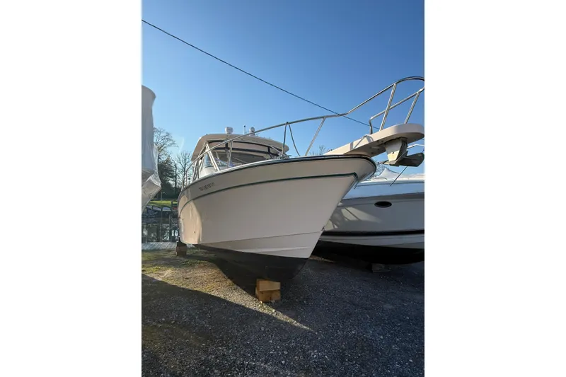 Slide: The Image of 2013 Grady-White Express 330 boat on dry dock under clear blue sky. - 1