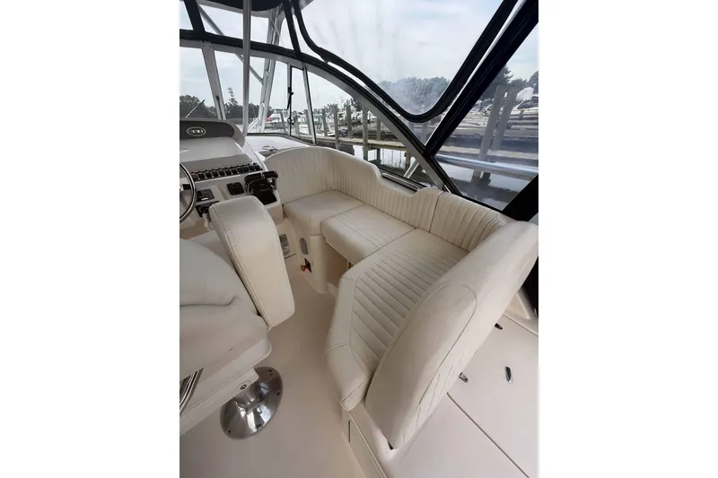Slide: The Image of Interior of 2013 Grady-White Express 330 boat with plush seating and helm station. - 13