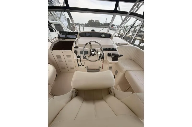 Slide: The Image of Interior view of 2013 Grady-White Express 330 boat cockpit with steering wheel and seating. - 14
