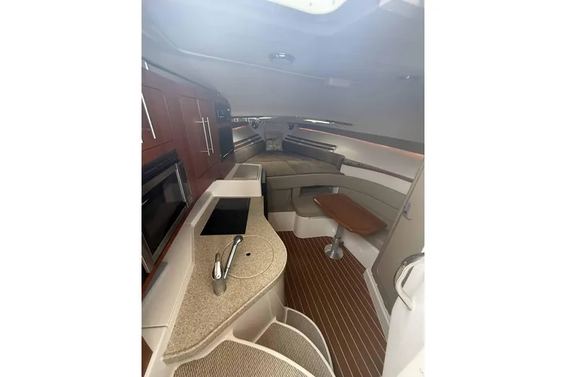 Slide: The Image of Interior of 2013 Grady-White Express 330 boat with modern kitchen and seating area. - 17