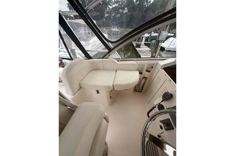 Slide: The Image of 2013 Grady-White Express 330 boat interior with white seating and helm view. - 22