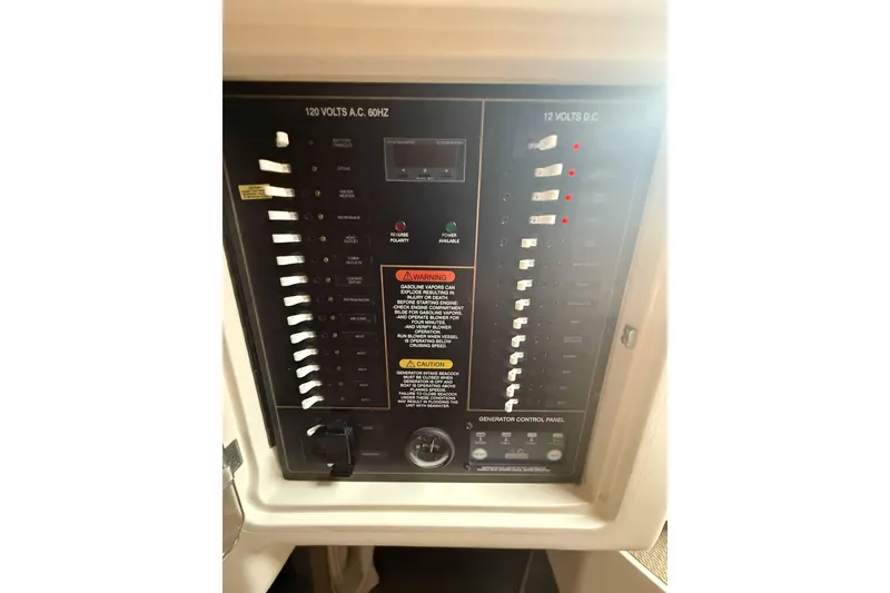 Slide: The Image of Electrical control panel on a 2013 Grady-White Express 330 boat. - 23