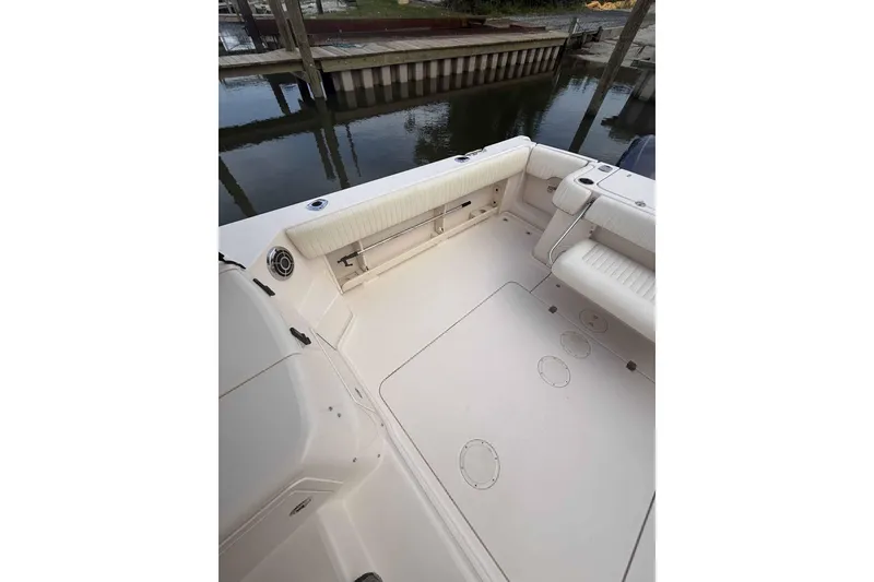 Slide: The Image of 2013 Grady-White Express 330 boat deck with seating and storage compartments. - 24