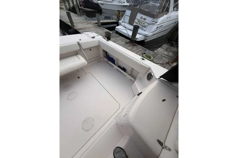 Slide: The Image of 2013 Grady-White Express 330 boat interior at dock, featuring spacious seating and clean design. - 26