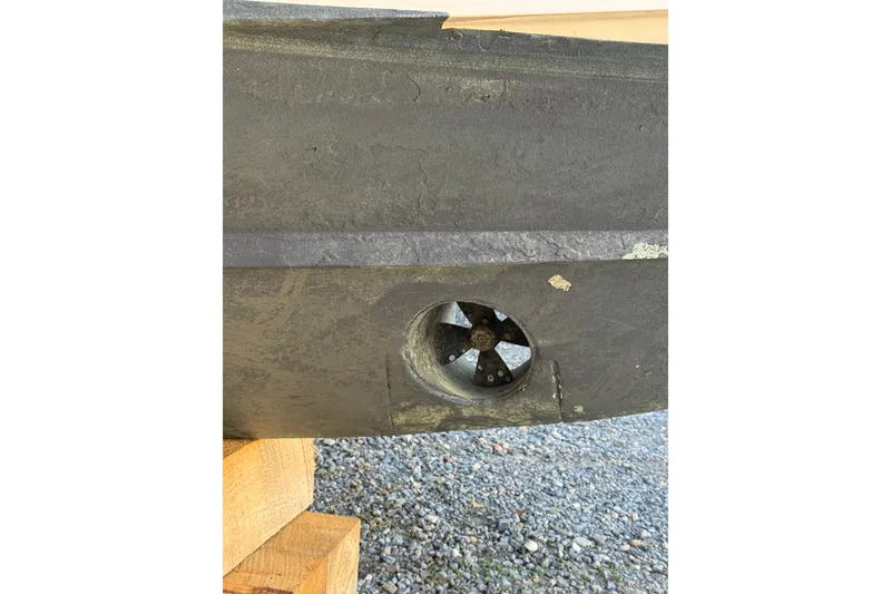 Slide: The Image of Close-up of a 2013 Grady-White Express 330 boat hull with a visible thruster. - 3