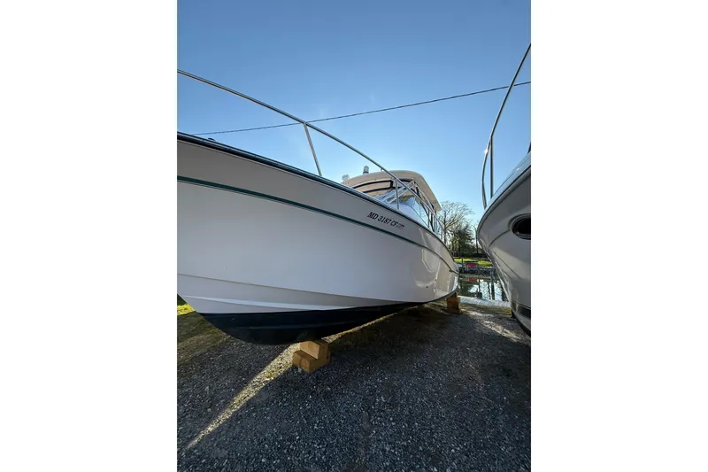 Slide: The Image of 2013 Grady-White Express 330 boat on dry dock under clear blue sky. - 6