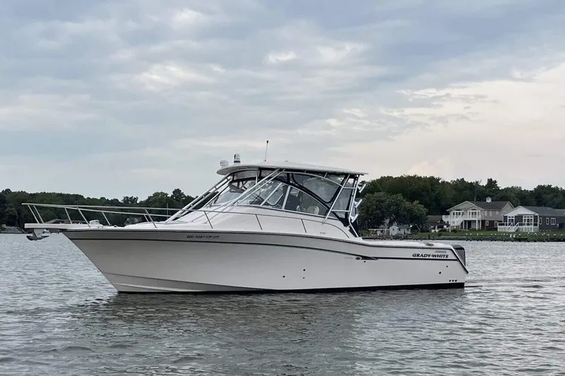 Slide: The Image of 2013 Grady-White Express 330 boat on calm water, cloudy sky background. - 7