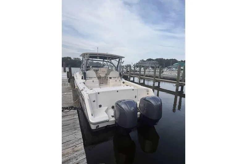 Slide: The Image of 2013 Grady-White Express 330 boat docked with dual outboard engines. - 8