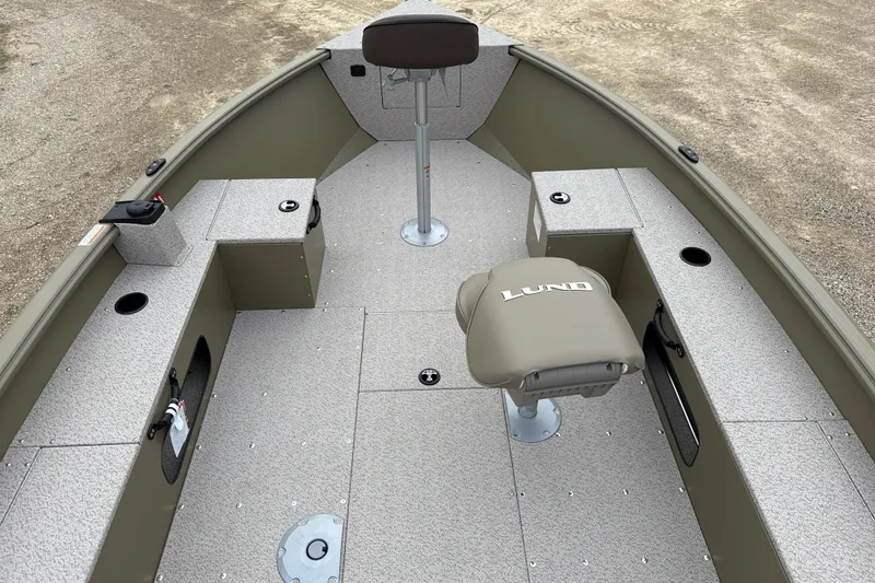 Slide: The Image of 2026 Lund 1675 Alaskan Tiller boat interior with seating and storage compartments. - 3