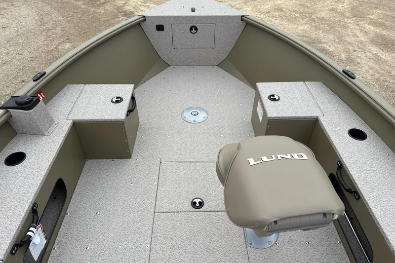 Slide: The Image of 2026 Lund 1675 Alaskan Tiller boat interior with seating and storage compartments. - 4