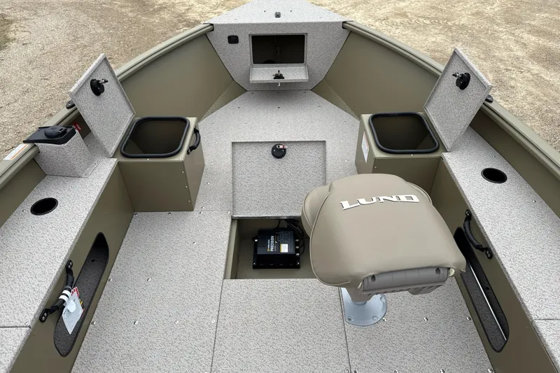 Slide: The Image of 2026 Lund 1675 Alaskan Tiller boat interior with storage compartments and seating. - 5
