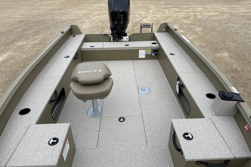 Slide: The Image of 2026 Lund 1675 Alaskan Tiller boat interior with seating and storage compartments. - 6