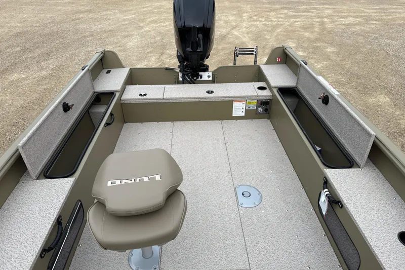 Slide: The Image of 2026 Lund 1675 Alaskan Tiller boat interior with seating and storage compartments. - 7