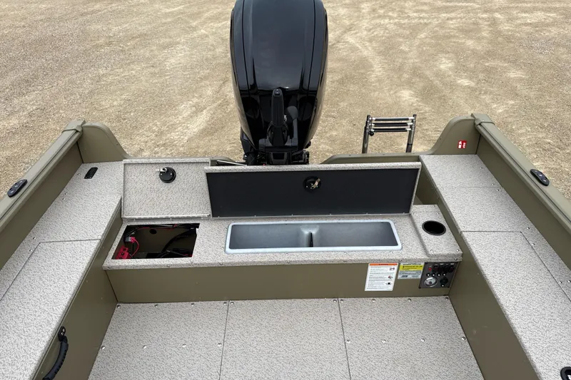 Slide: The Image of 2026 Lund 1675 Alaskan Tiller boat interior with motor and storage compartments. - 8