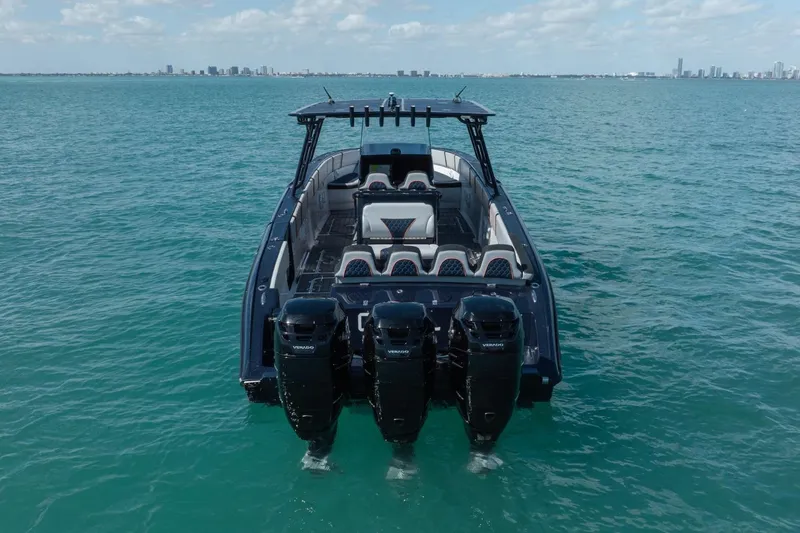 Slide: The Image of 2014 Midnight Express 37 Open boat with four engines on turquoise water. - 11