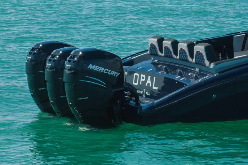 Slide: The Image of 2014 Midnight Express 37 Open boat with triple Mercury Verado engines on turquoise water. - 12