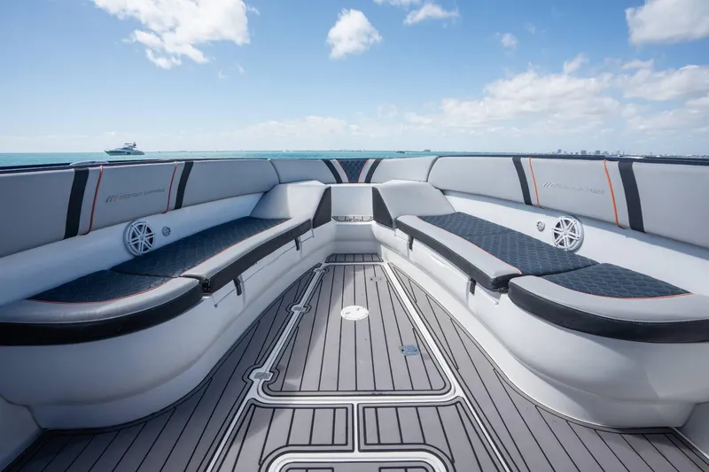 Slide: The Image of Luxurious seating on a 2014 Midnight Express 37 Open boat under a clear blue sky. - 14