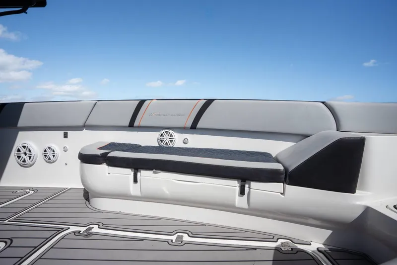 Slide: The Image of 2014 Midnight Express 37 Open boat interior with cushioned seating and speakers under a clear sky. - 17