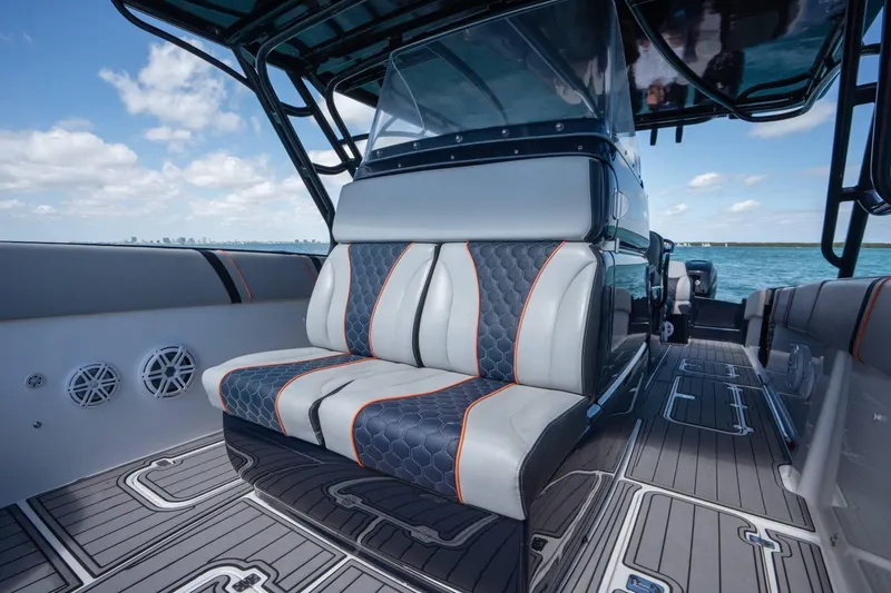 Slide: The Image of Luxurious seating on a 2014 Midnight Express 37 Open boat, with sleek design and ocean backdrop. - 18
