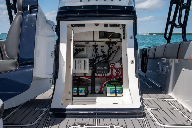 Slide: The Image of Electrical compartment of a 2014 Midnight Express 37 Open boat, featuring batteries and wiring. - 19