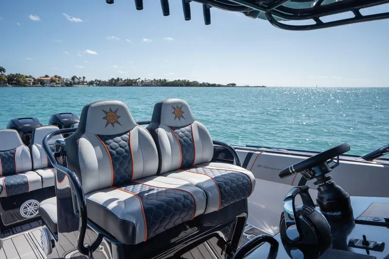 Slide: The Image of 2014 Midnight Express 37 Open boat interior with luxurious seating on a sunny day at sea. - 20