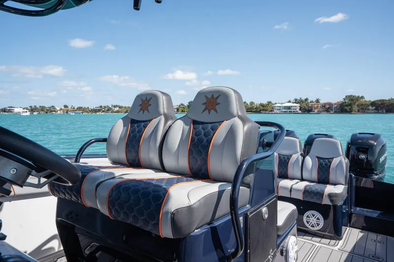 Slide: The Image of Luxury seating on a 2014 Midnight Express 37 Open boat, with scenic waterfront view. - 21