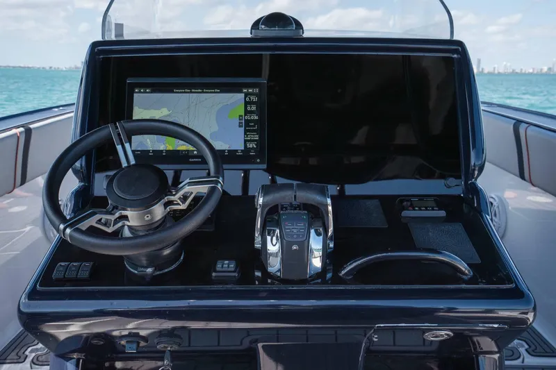 Slide: The Image of Cockpit of 2014 Midnight Express 37 Open boat with navigation display and controls. - 25