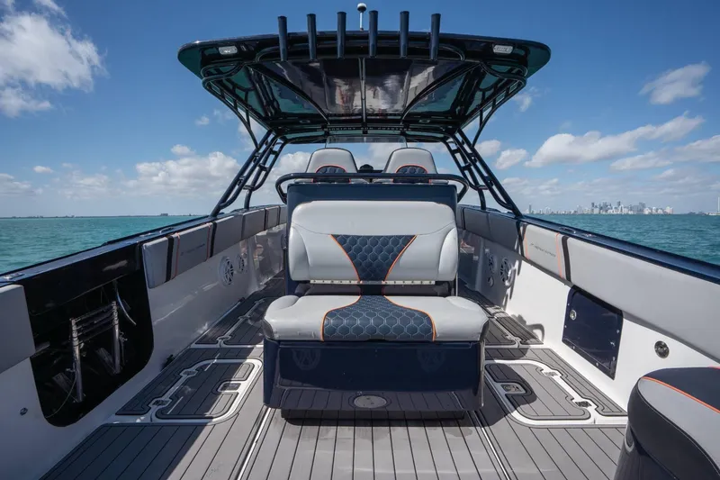 Slide: The Image of 2014 Midnight Express 37 Open boat interior with stylish seating, ocean view, and city skyline. - 30