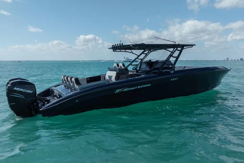 Slide: The Image of 2014 Midnight Express 37 Open boat on turquoise water under blue sky. - 6