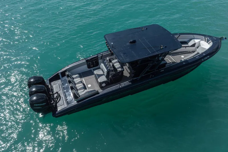 Slide: The Image of 2014 Midnight Express 37 Open boat on clear turquoise water, aerial view. - 9