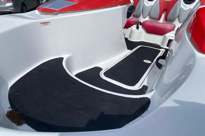 Slide: The Image of 2007 Seadoo 150 Speedster interior with red and white seating, black flooring. - 12