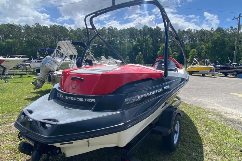Slide: The Image of 2007 Seadoo 150 SPEEDSTER boat on trailer, parked outdoors under blue sky. - 4