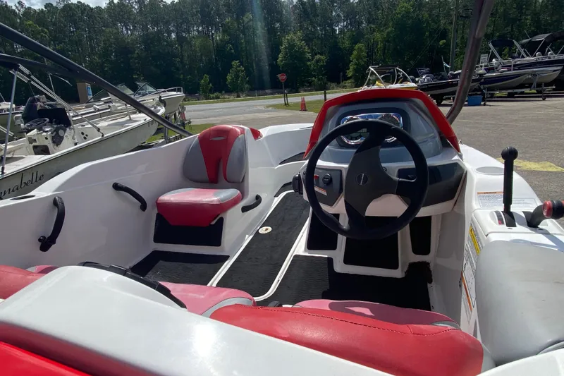 Slide: The Image of 2007 Seadoo 150 Speedster interior with red and white seating, steering wheel, and dashboard. - 5