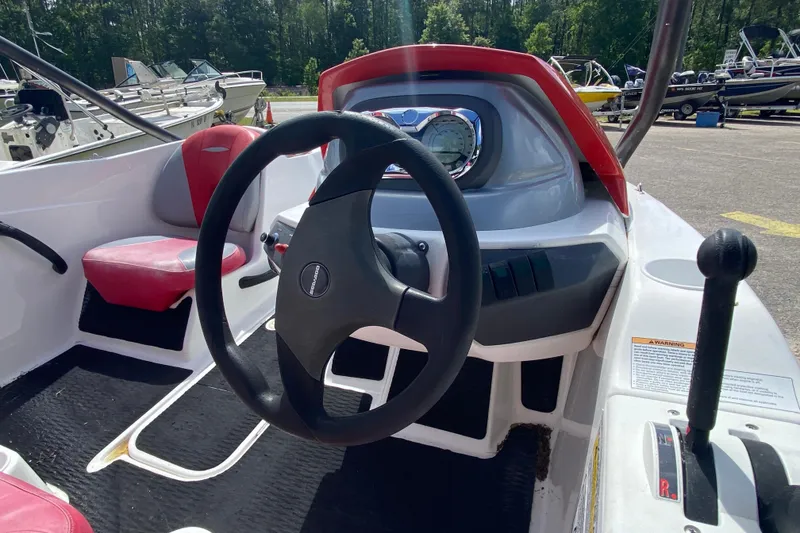 Slide: The Image of 2007 Seadoo 150 Speedster boat interior with steering wheel and dashboard controls. - 6